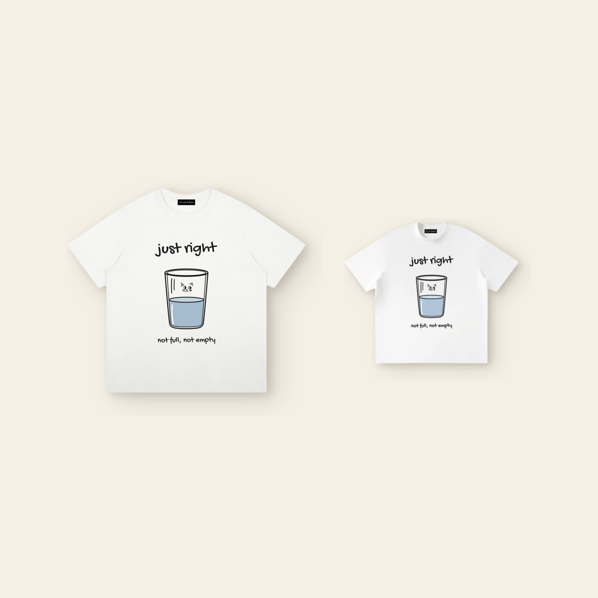 One kids' t-shirt and one adult t-shirt laid side by side