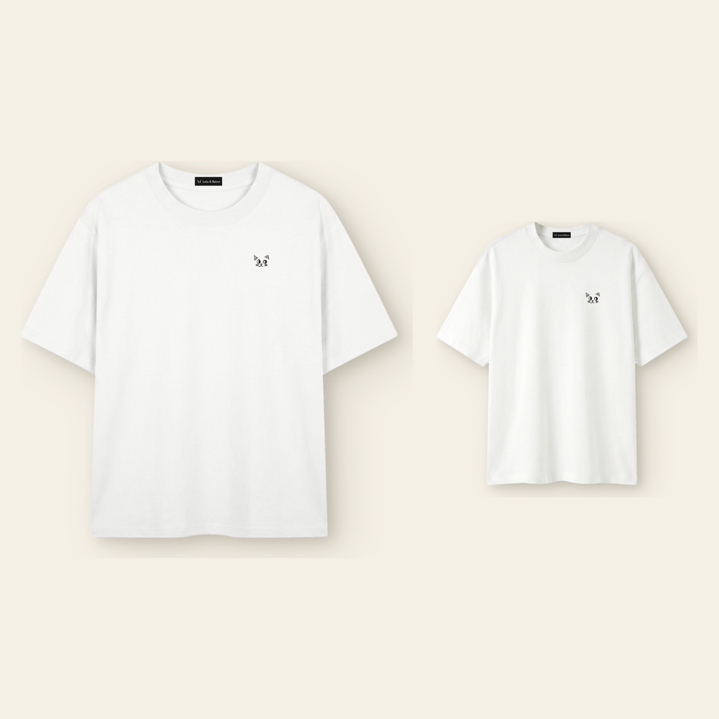 One kids' t-shirt and one adult t-shirt laid side by side