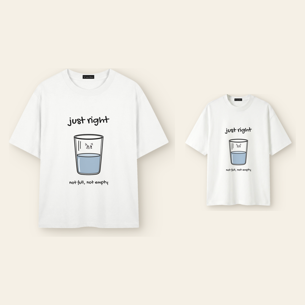 One kids' t-shirt and one adult t-shirt laid side by side