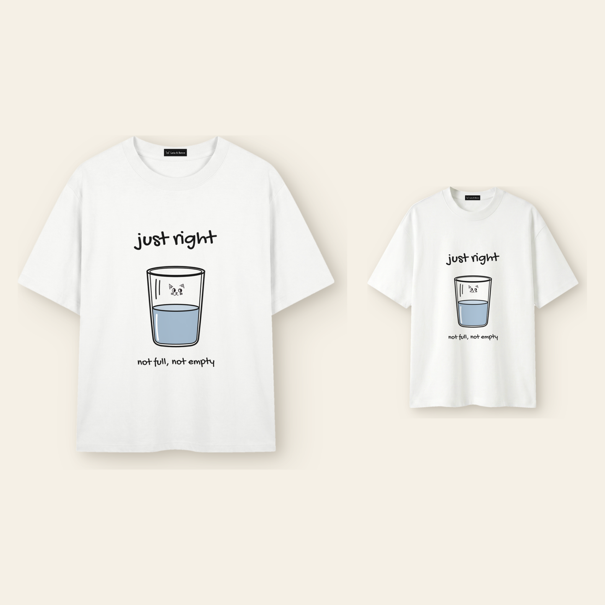 One kids' t-shirt and one adult t-shirt laid side by side