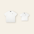 One kids' t-shirt and one adult t-shirt laid side by side