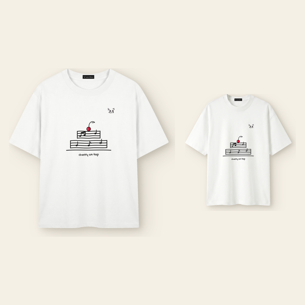 One kids' t-shirt and one adult t-shirt laid side by side