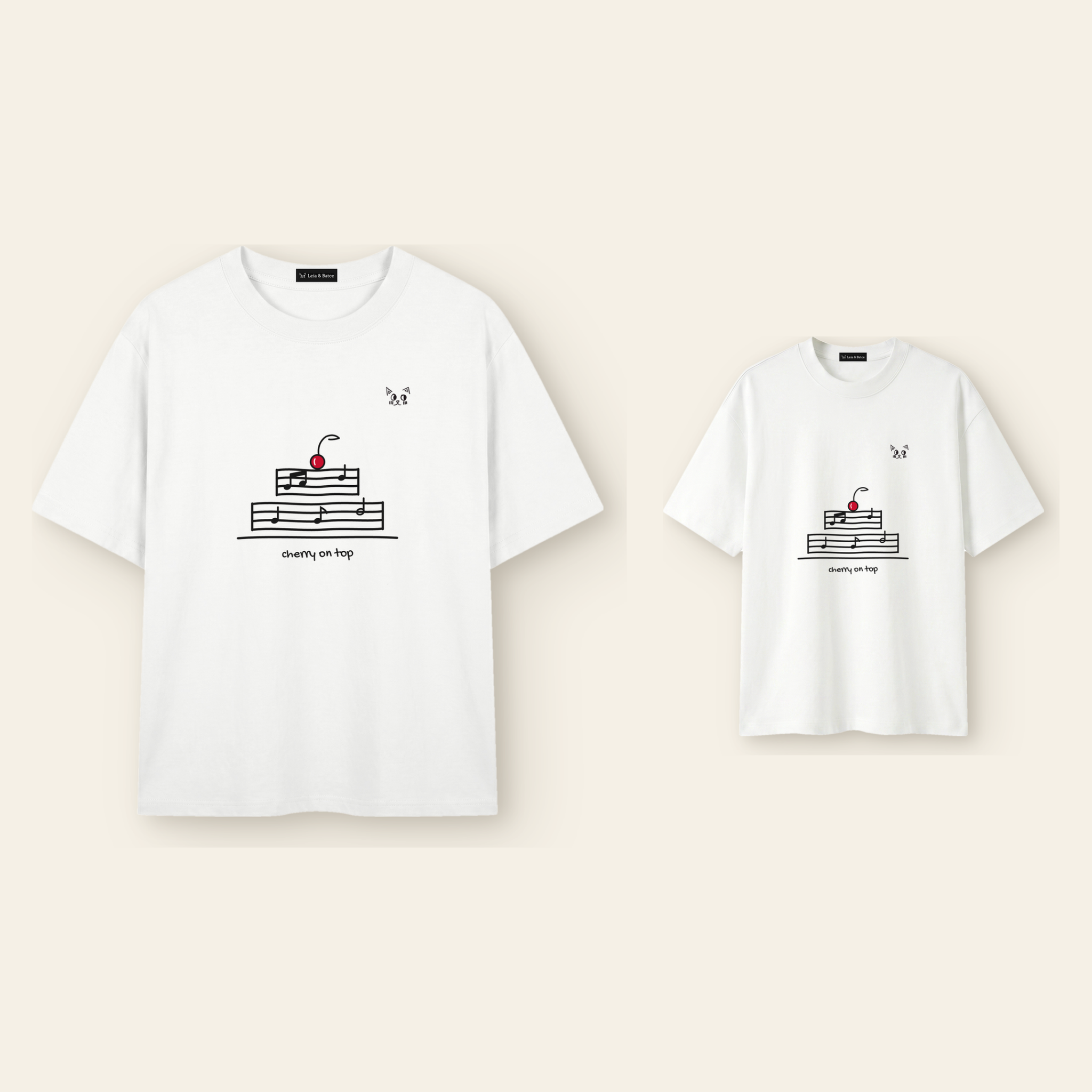 One kids' t-shirt and one adult t-shirt laid side by side