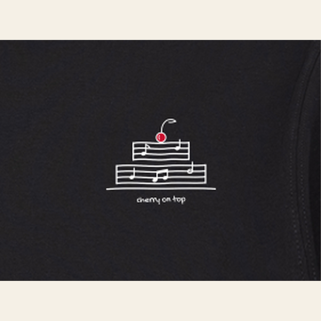 Close-up of the print on the Black adult piece — the kids' piece carries the same design