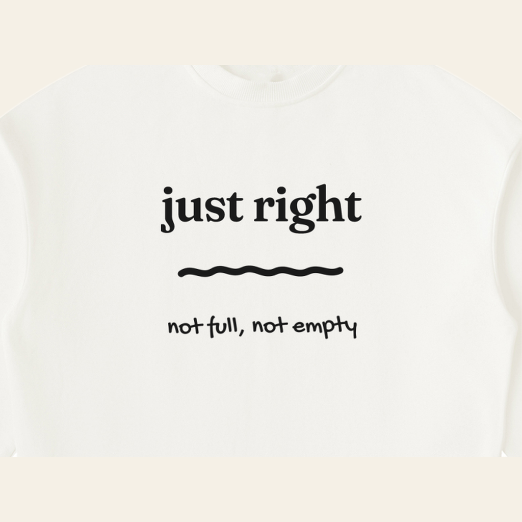 Close-up of the Just Right mark printed on the Beige sweatshirt