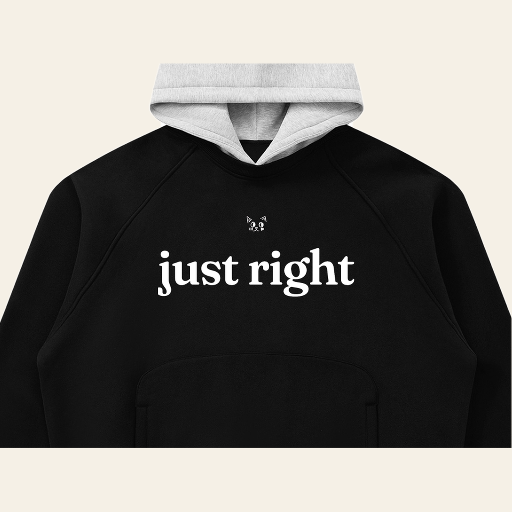 Close-up of the Just Right mark printed on the Black / Heather Gray hoodie