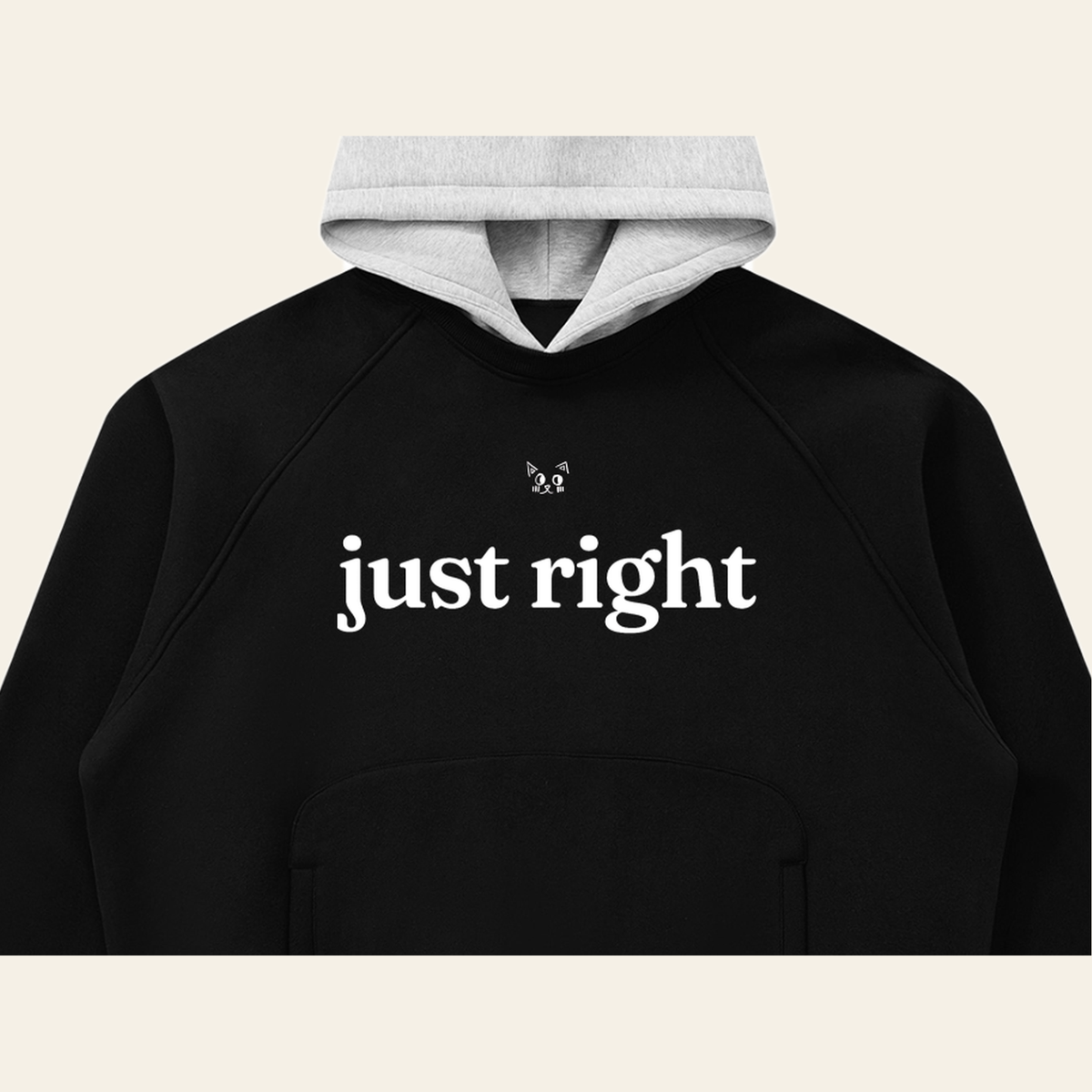 Close-up of the Just Right mark printed on the Black / Heather Gray hoodie