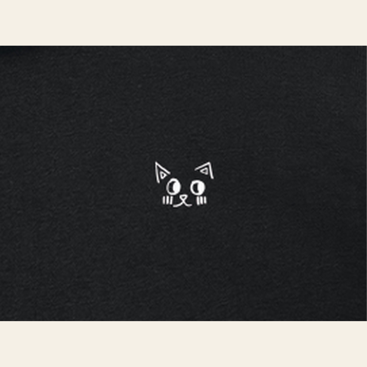 Close-up of the Just Right mark printed on the Black zip hoodie