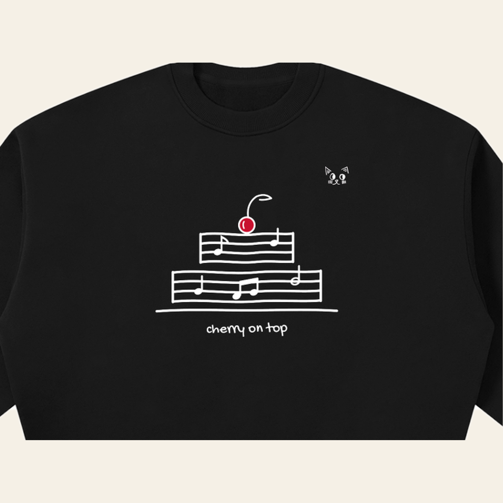 Close-up of the Cherry on Top mark printed on the Black sweatshirt