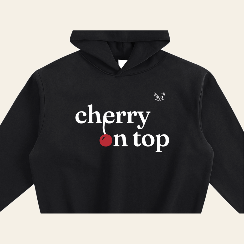 Close-up of the Cherry on Top mark printed on the Black hoodie