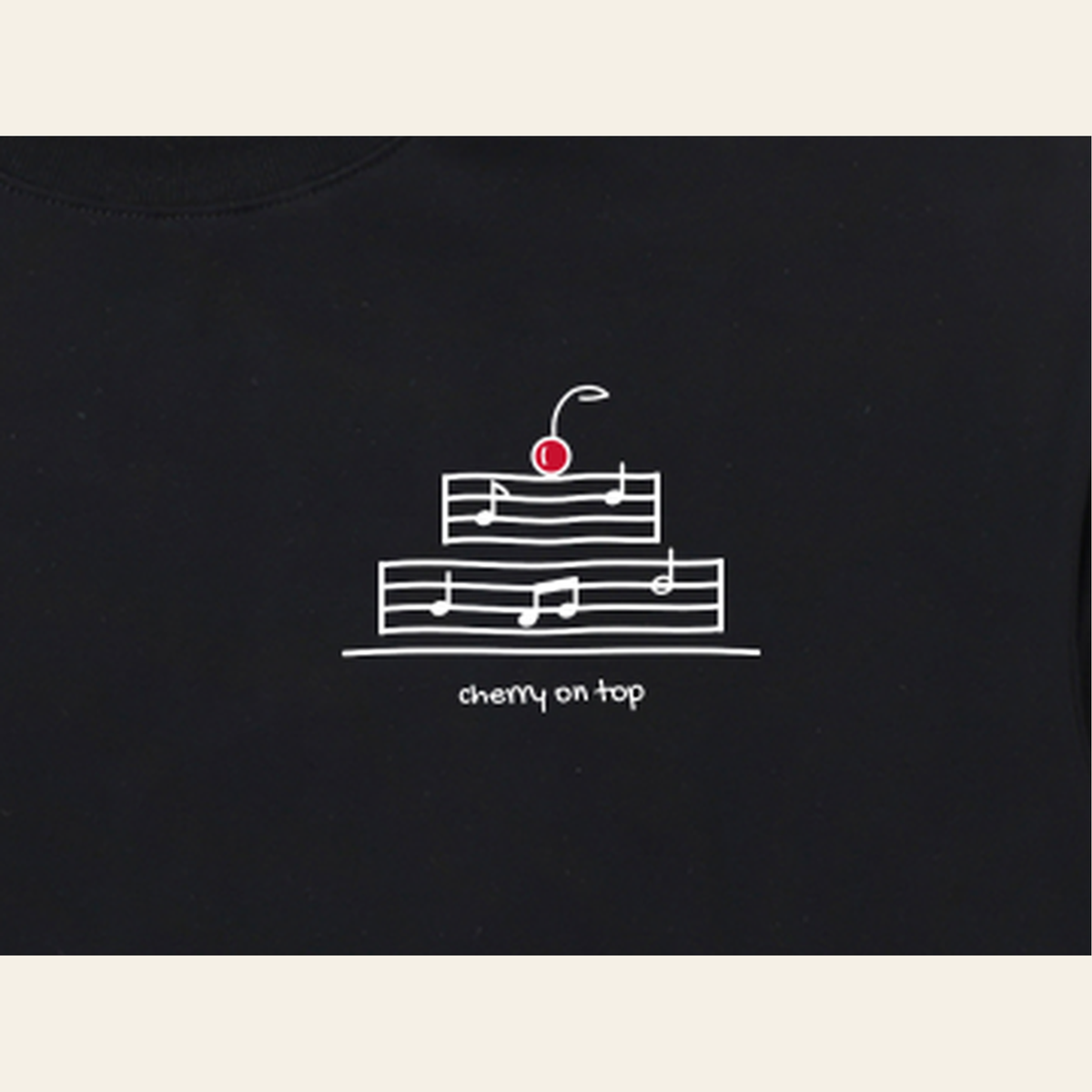 Close-up of the Cherry on Top mark printed on the Black long-sleeve t-shirt