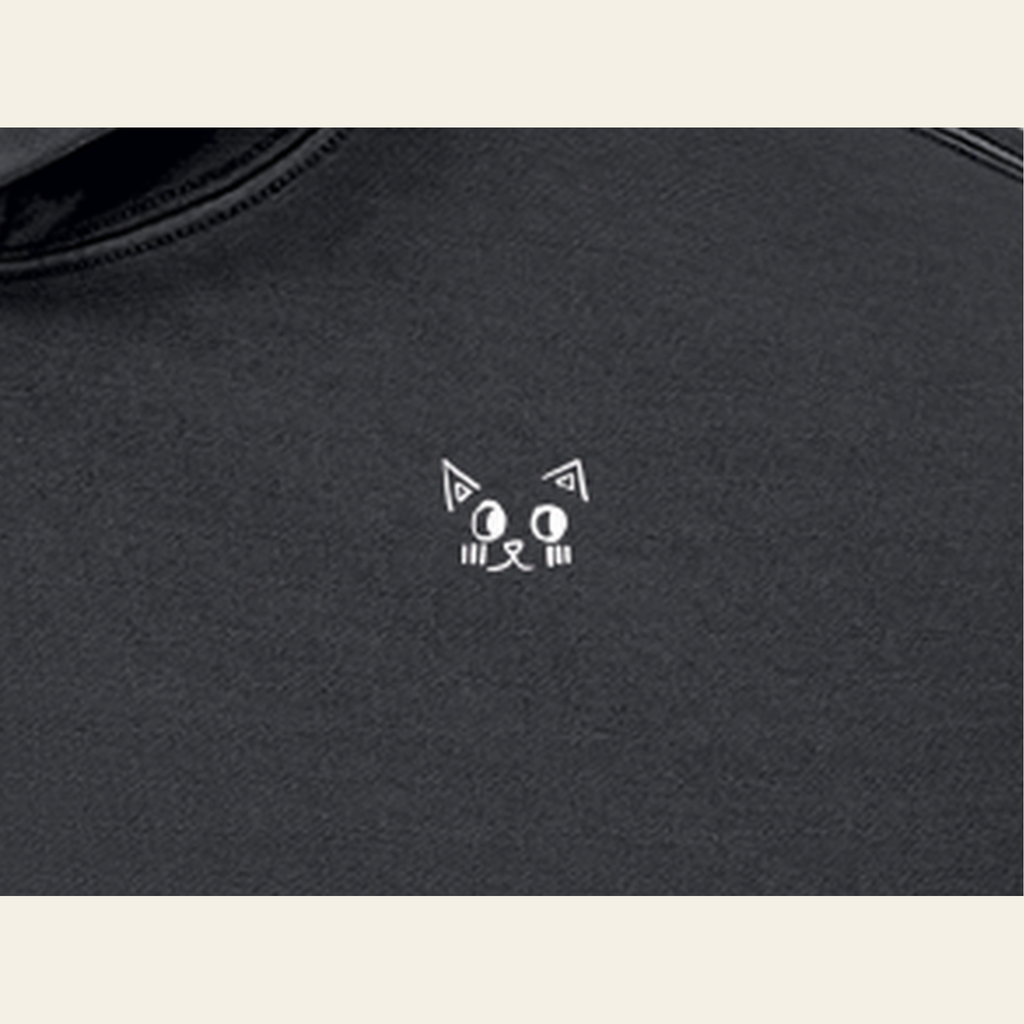 Close-up of the Batce mark printed on the Black hoodie