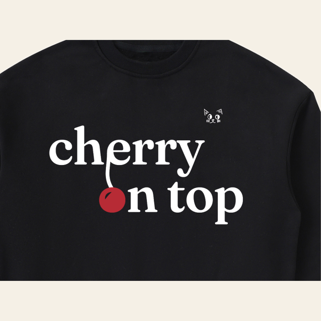 Close-up of the Cherry on Top mark printed on the Black sweatshirt