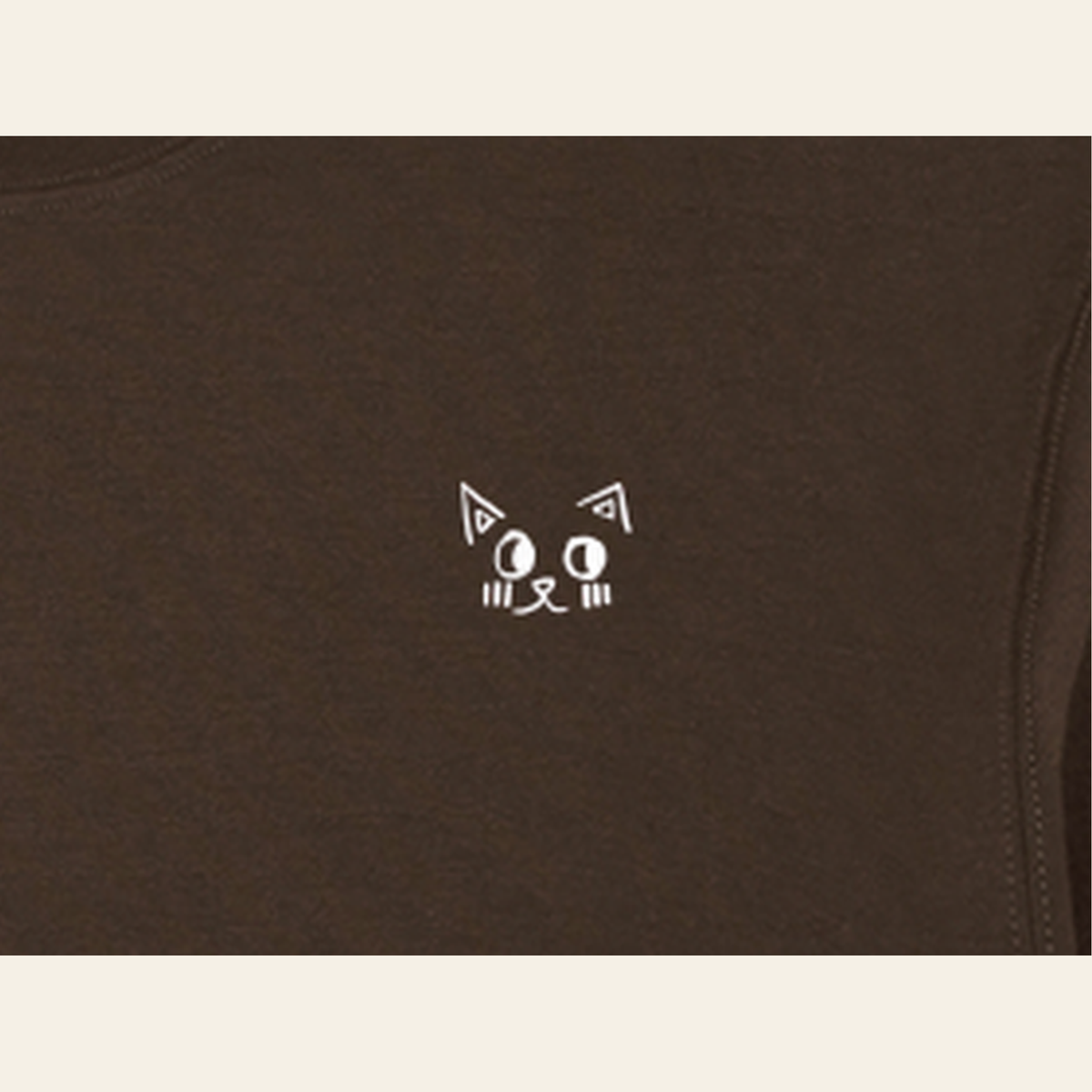 Close-up of the Batce mark printed on the Brown long-sleeve t-shirt
