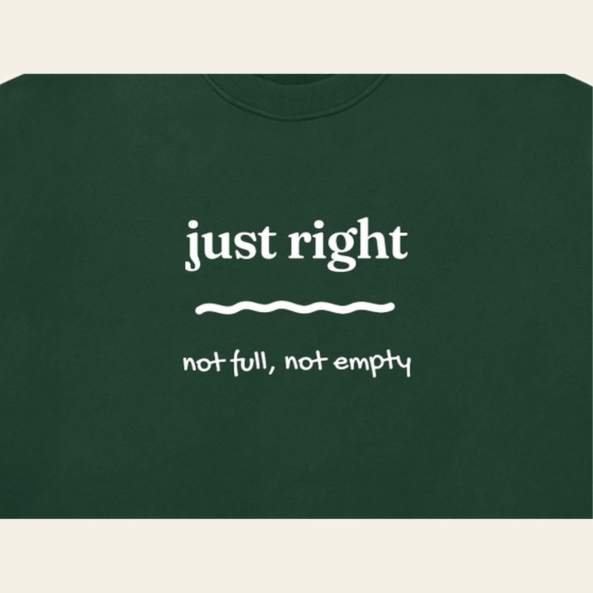 Close-up of the Just Right mark printed on the Dark Green sweatshirt