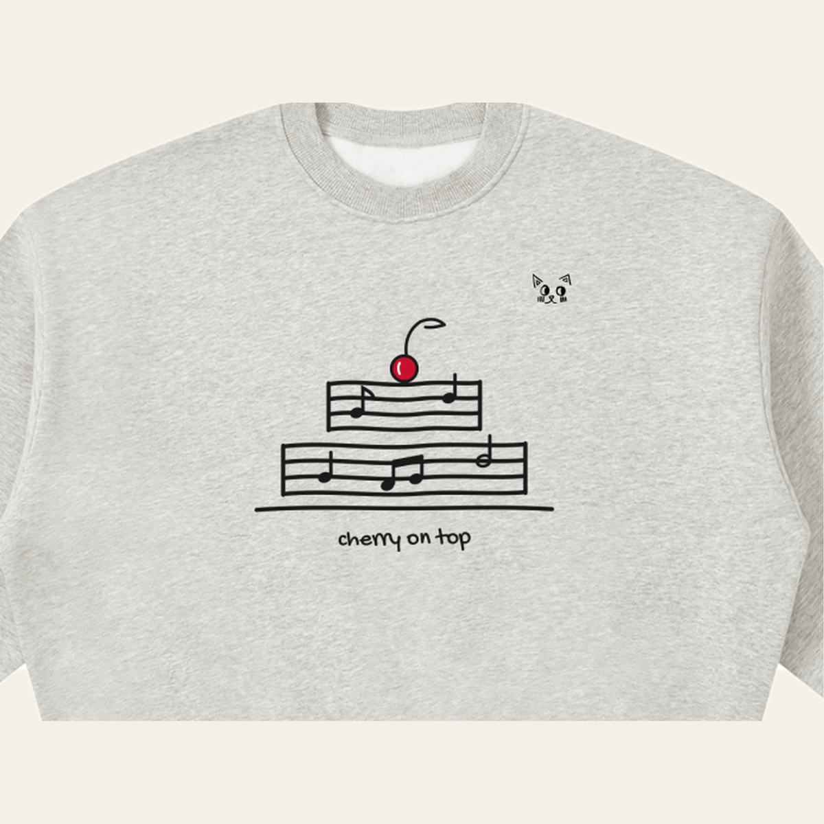 Close-up of the Cherry on Top mark printed on the Heather Gray sweatshirt