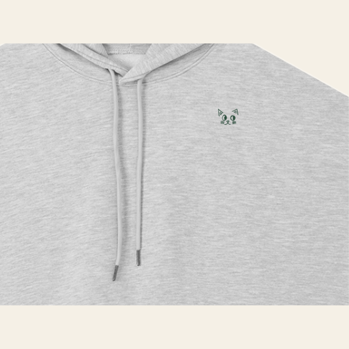 Close-up of the Batce mark printed on the Heather Gray hoodie