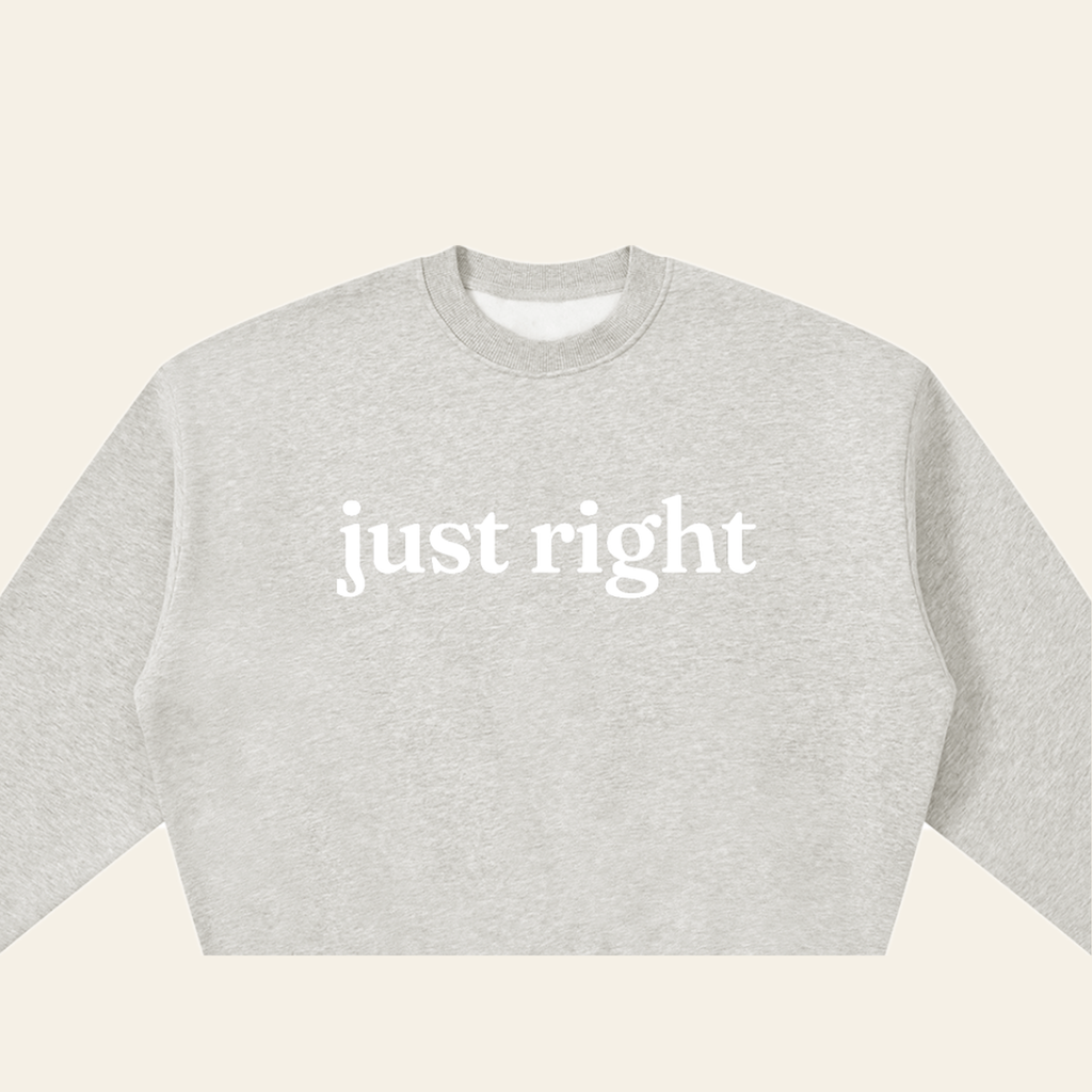 Close-up of the Just Right mark printed on the Heather Gray sweatshirt