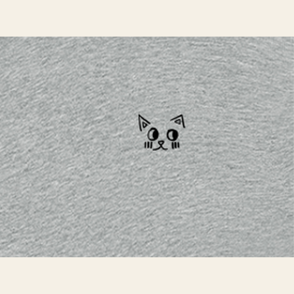 Close-up of the Just Right mark printed on the Heather Gray zip hoodie