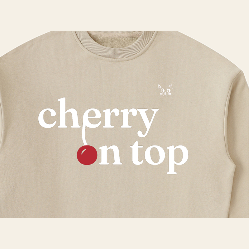 Close-up of the Cherry on Top mark printed on the Khaki sweatshirt