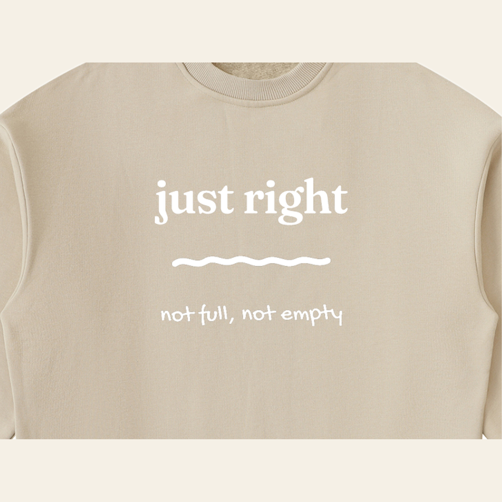 Close-up of the Just Right mark printed on the Khaki sweatshirt