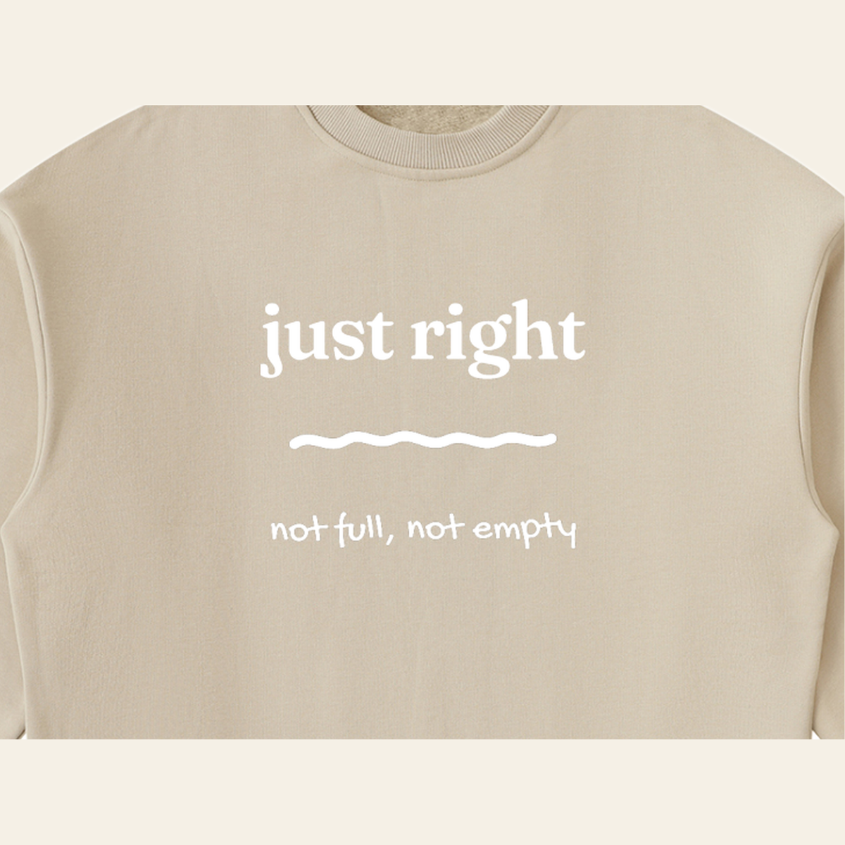 Close-up of the Just Right mark printed on the Khaki sweatshirt