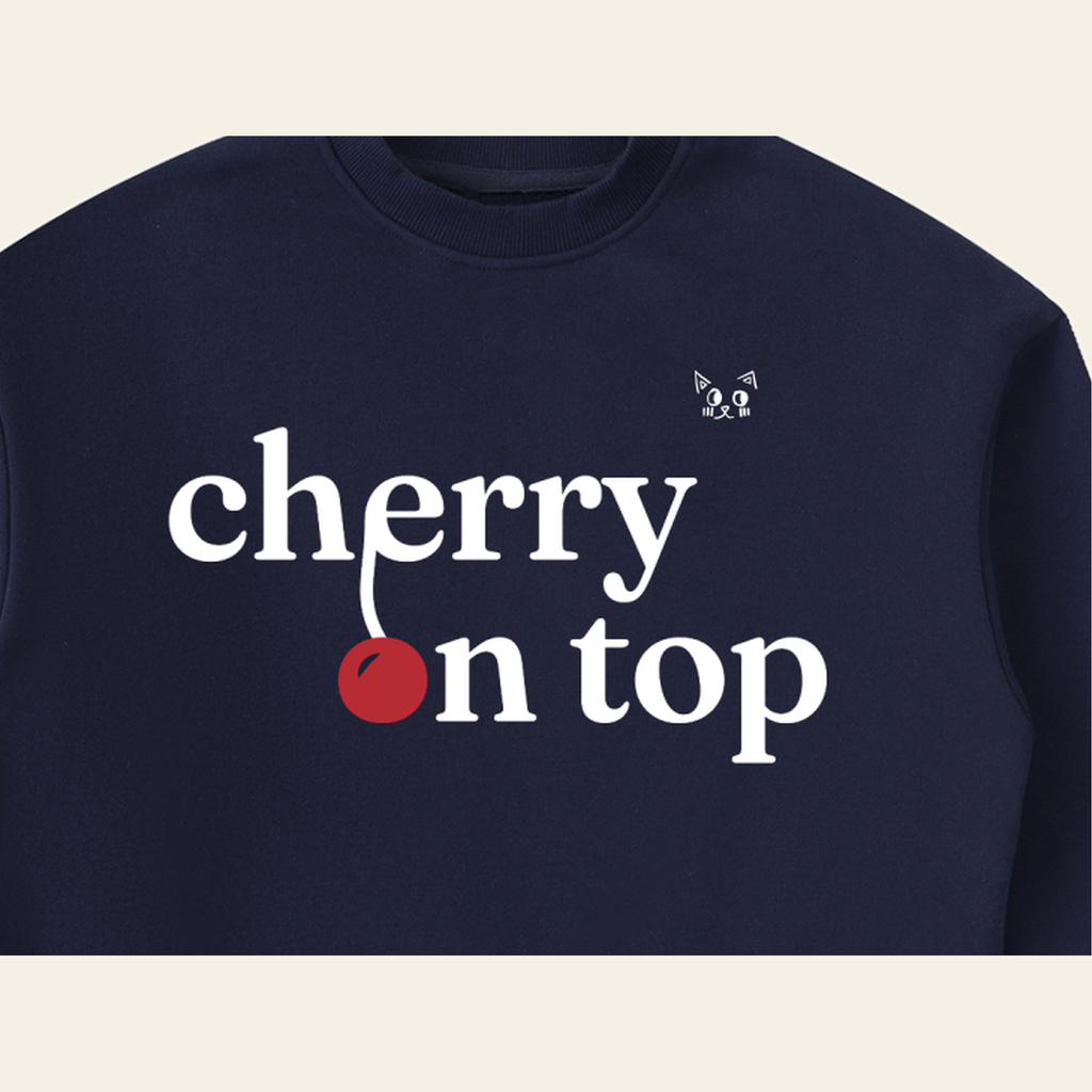 Close-up of the Cherry on Top mark printed on the Navy Blue sweatshirt