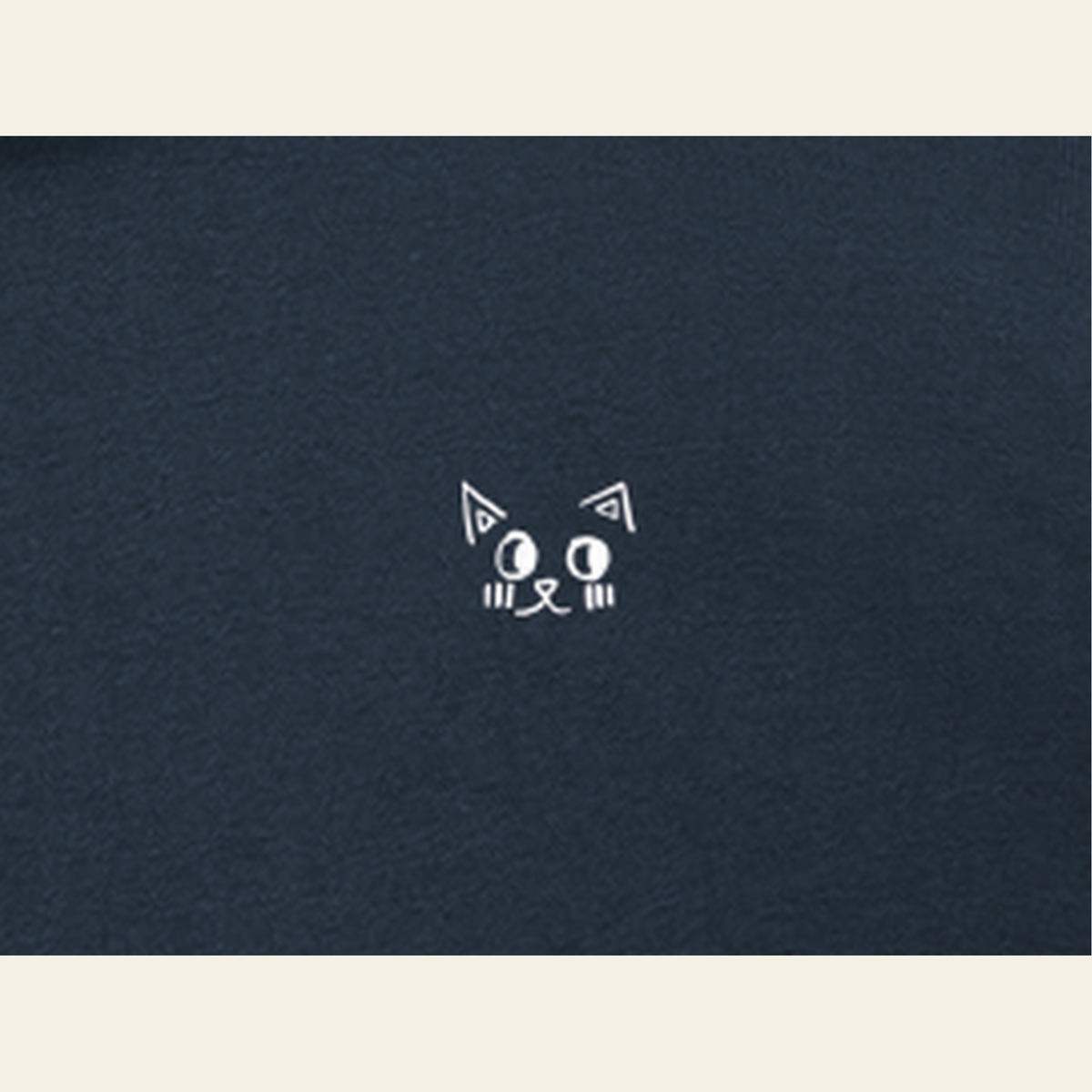 Close-up of the Just Right mark printed on the Navy Blue zip hoodie