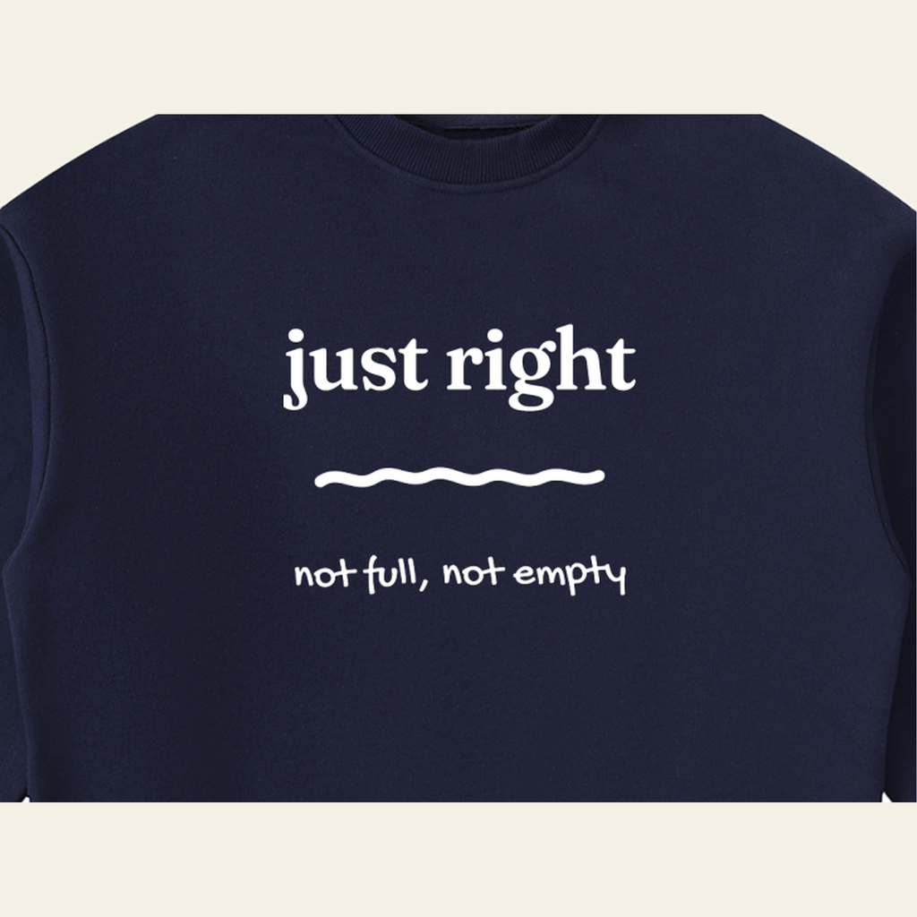 Close-up of the Just Right mark printed on the Navy Blue sweatshirt