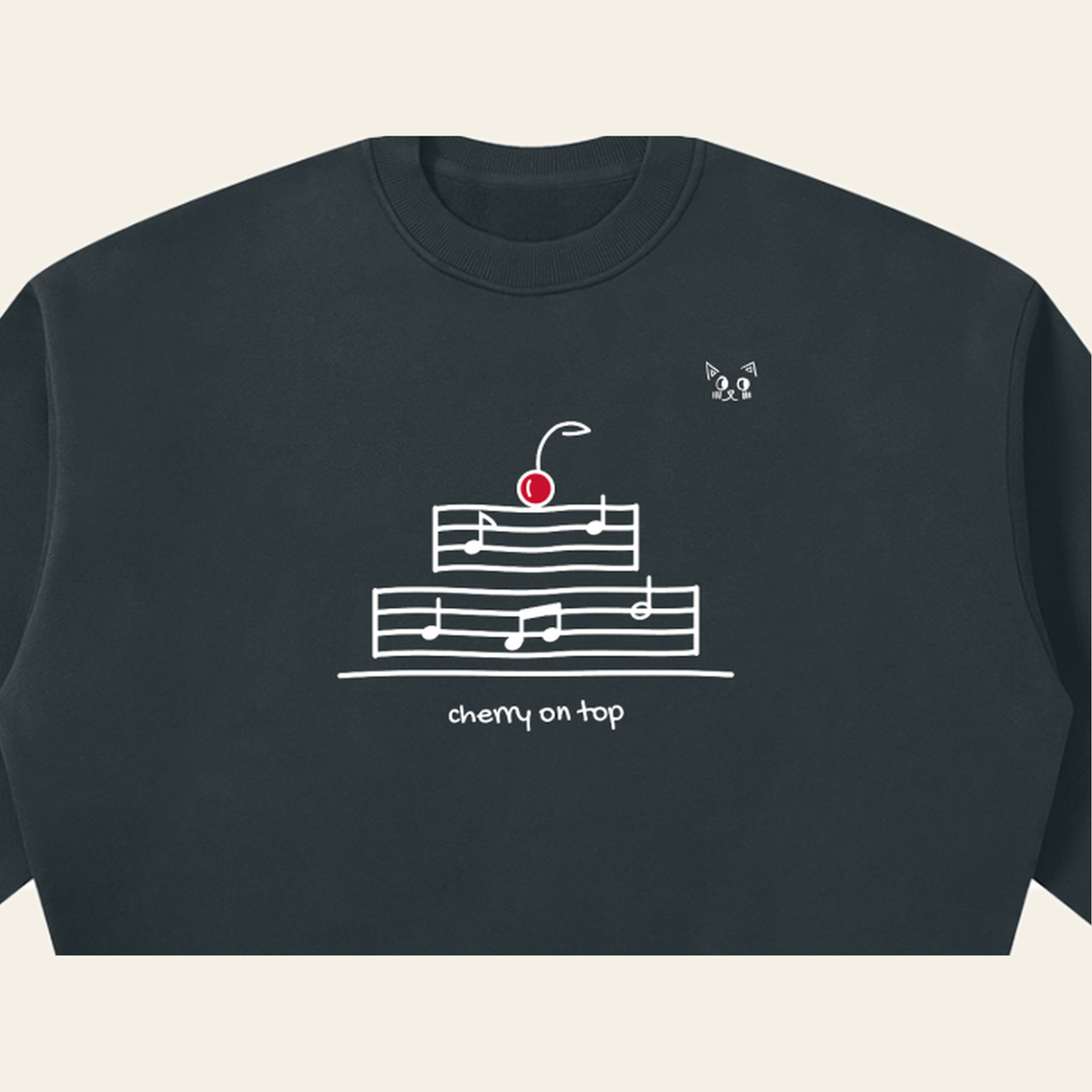 Close-up of the Cherry on Top mark printed on the Navy Blue sweatshirt