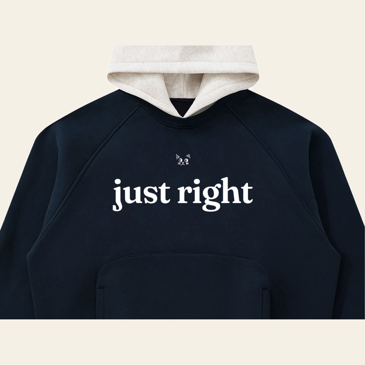 Close-up of the Just Right mark printed on the Navy / Oatmeal hoodie