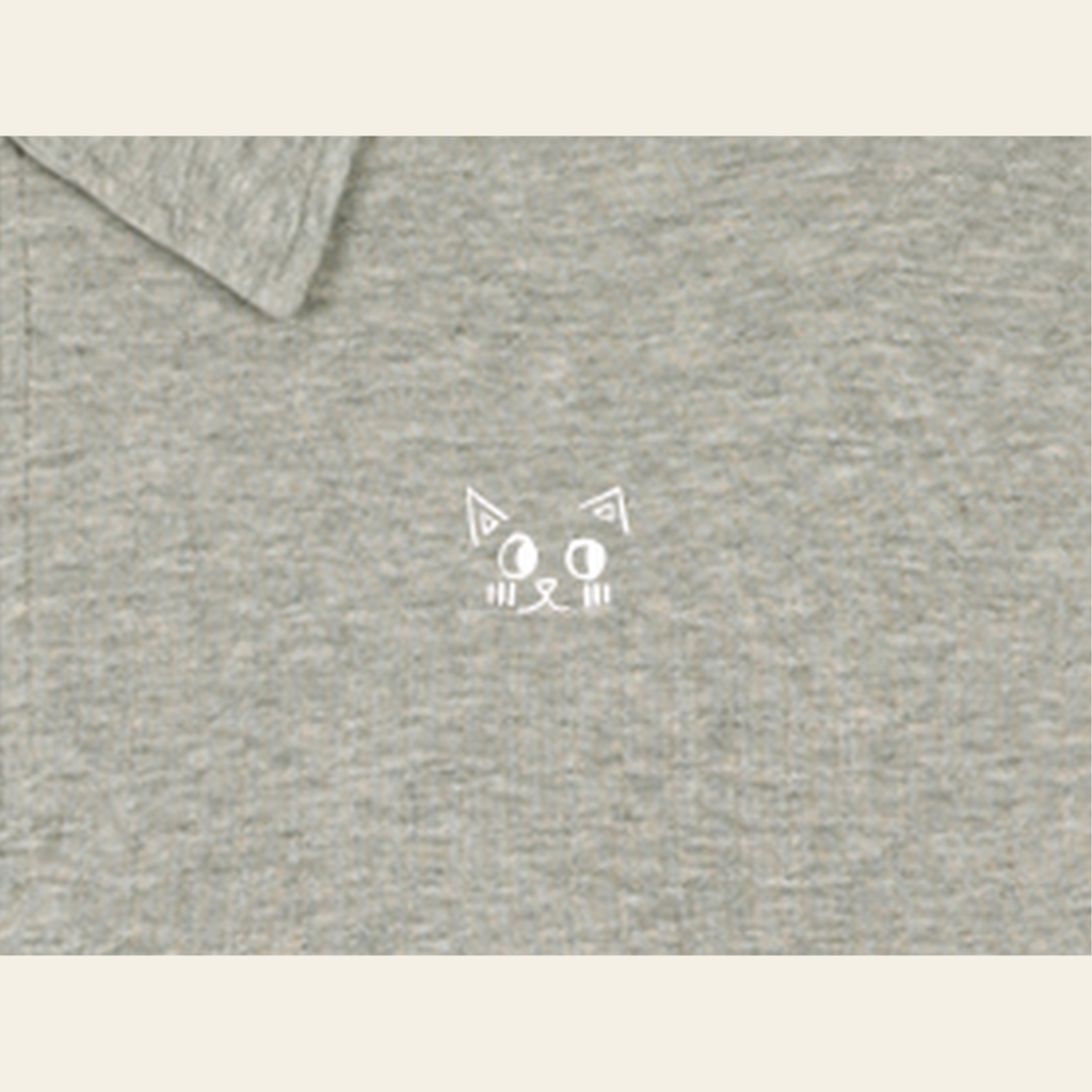 Close-up of the Batce mark printed on the Oatmeal quarter-zip