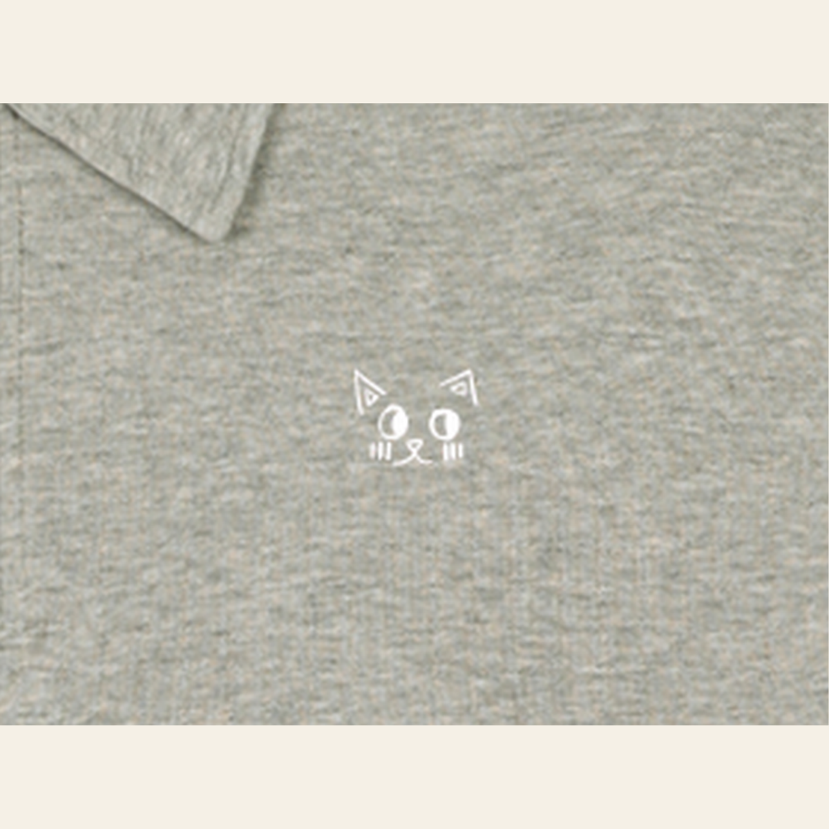 Close-up of the Batce mark printed on the Oatmeal quarter-zip