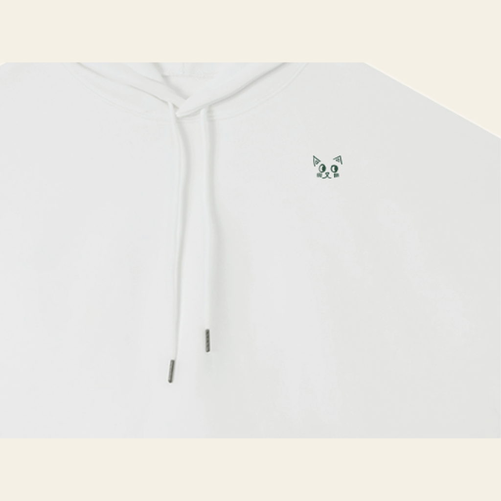 Close-up of the Batce mark printed on the White hoodie