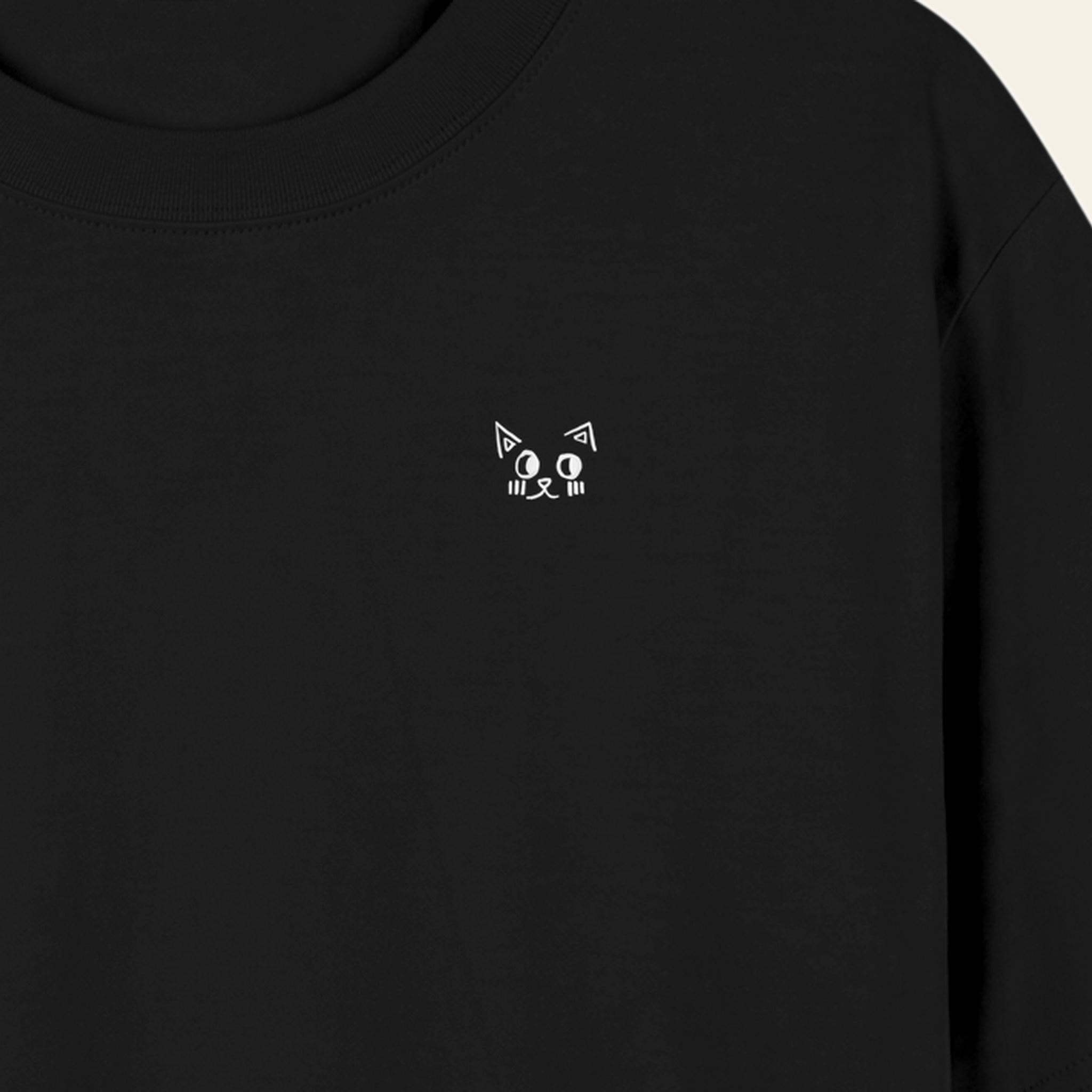 Close-up of the small hand-drawn Batce mark printed on the chest