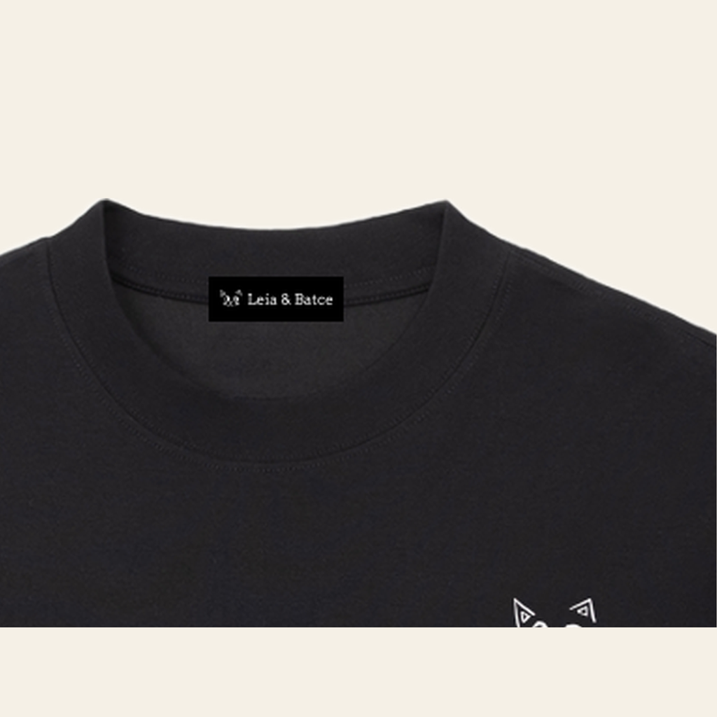 The Leia & Batce label sewn inside the back collar of the Black long-sleeve t-shirt — the same label is in every piece