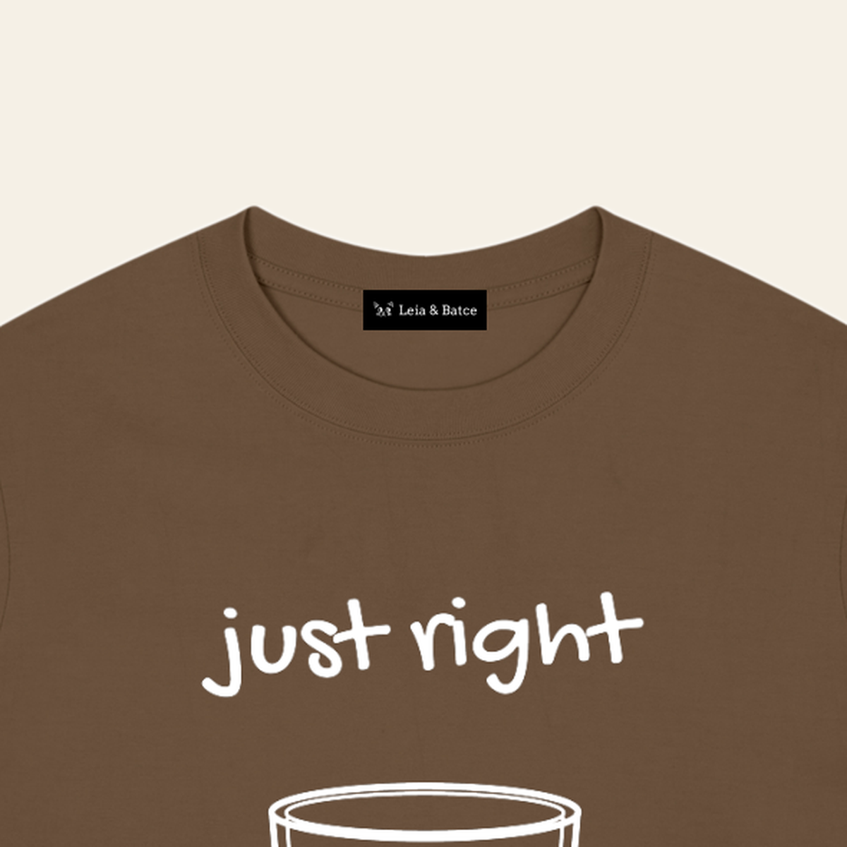 The Leia & Batce label sewn inside the back collar of the Brown adult t-shirt