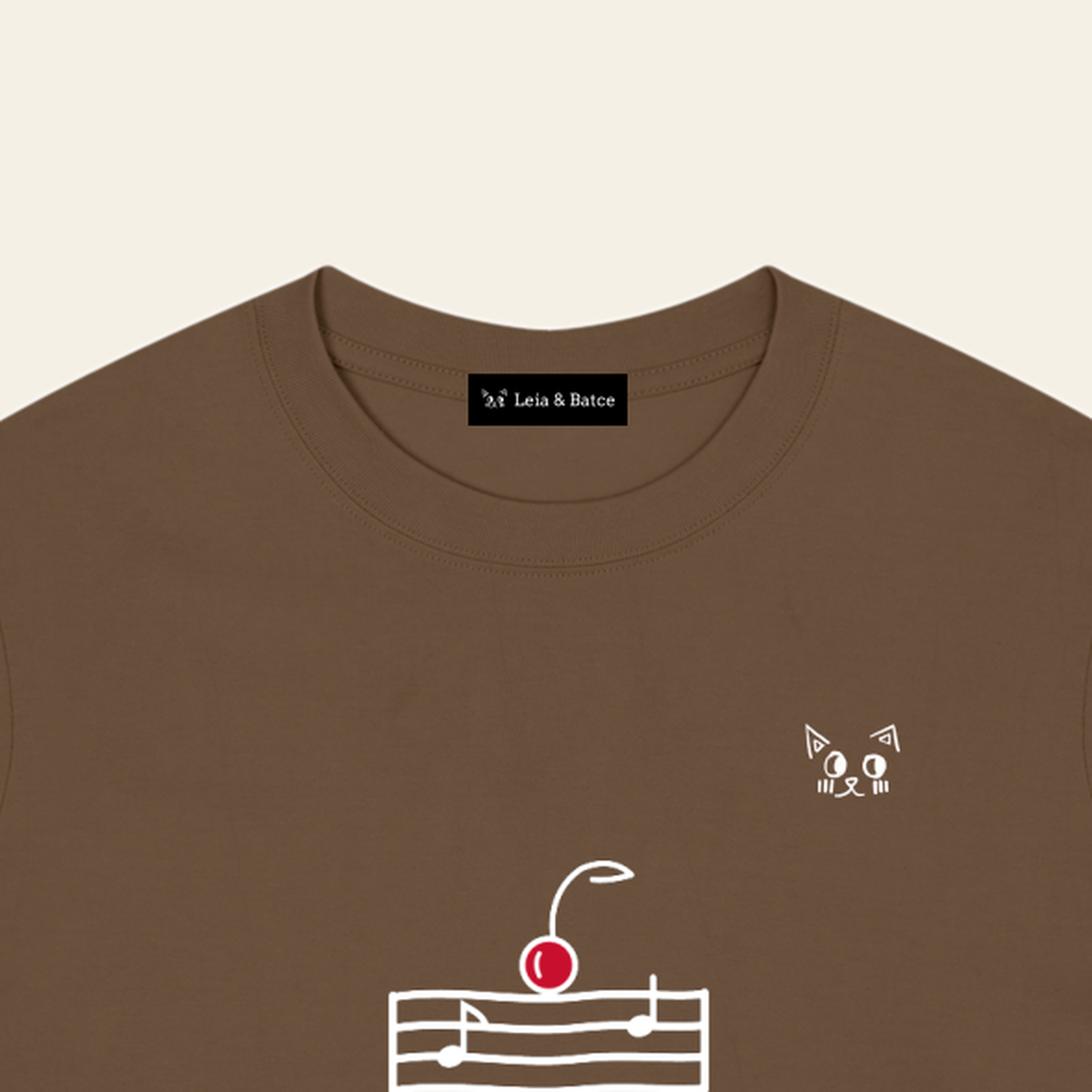 The Leia & Batce label sewn inside the back collar of the Brown adult t-shirt