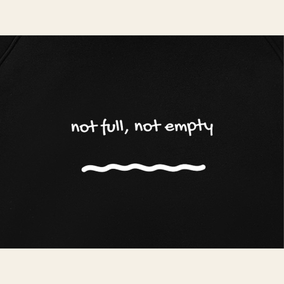 Close-up of the Just Right print on the back of the Black / Heather Gray hoodie