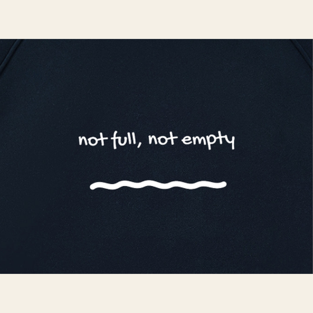 Close-up of the Just Right print on the back of the Navy / Oatmeal hoodie