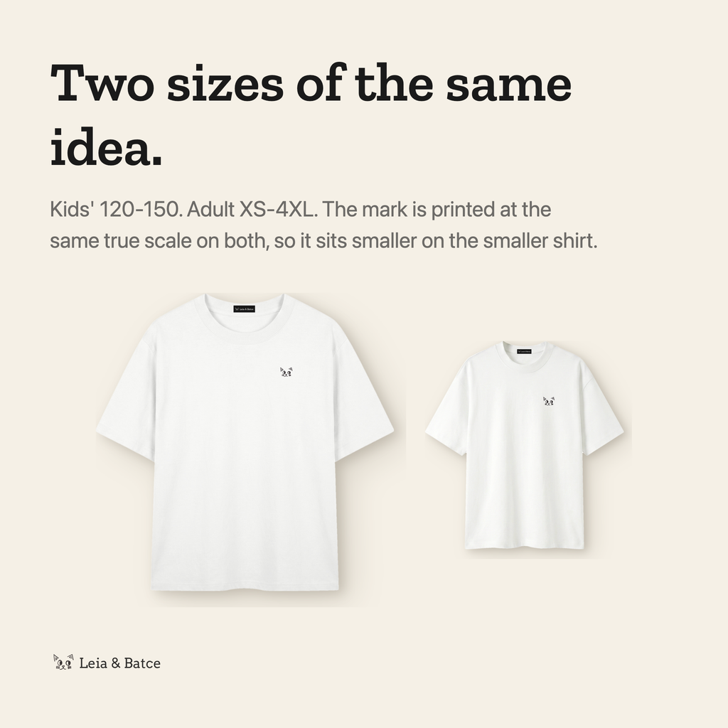 The same mark printed at true scale on the kids' and adult shirts