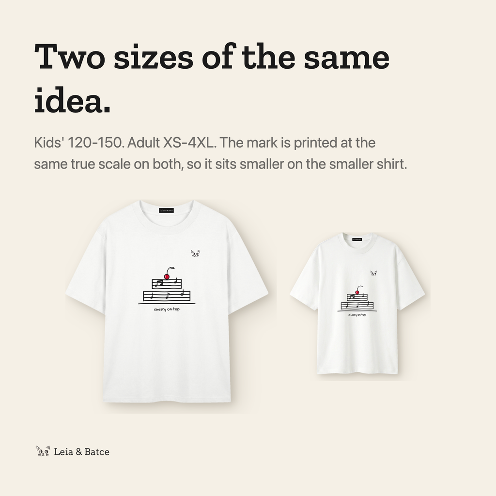 The same mark printed at true scale on the kids' and adult shirts