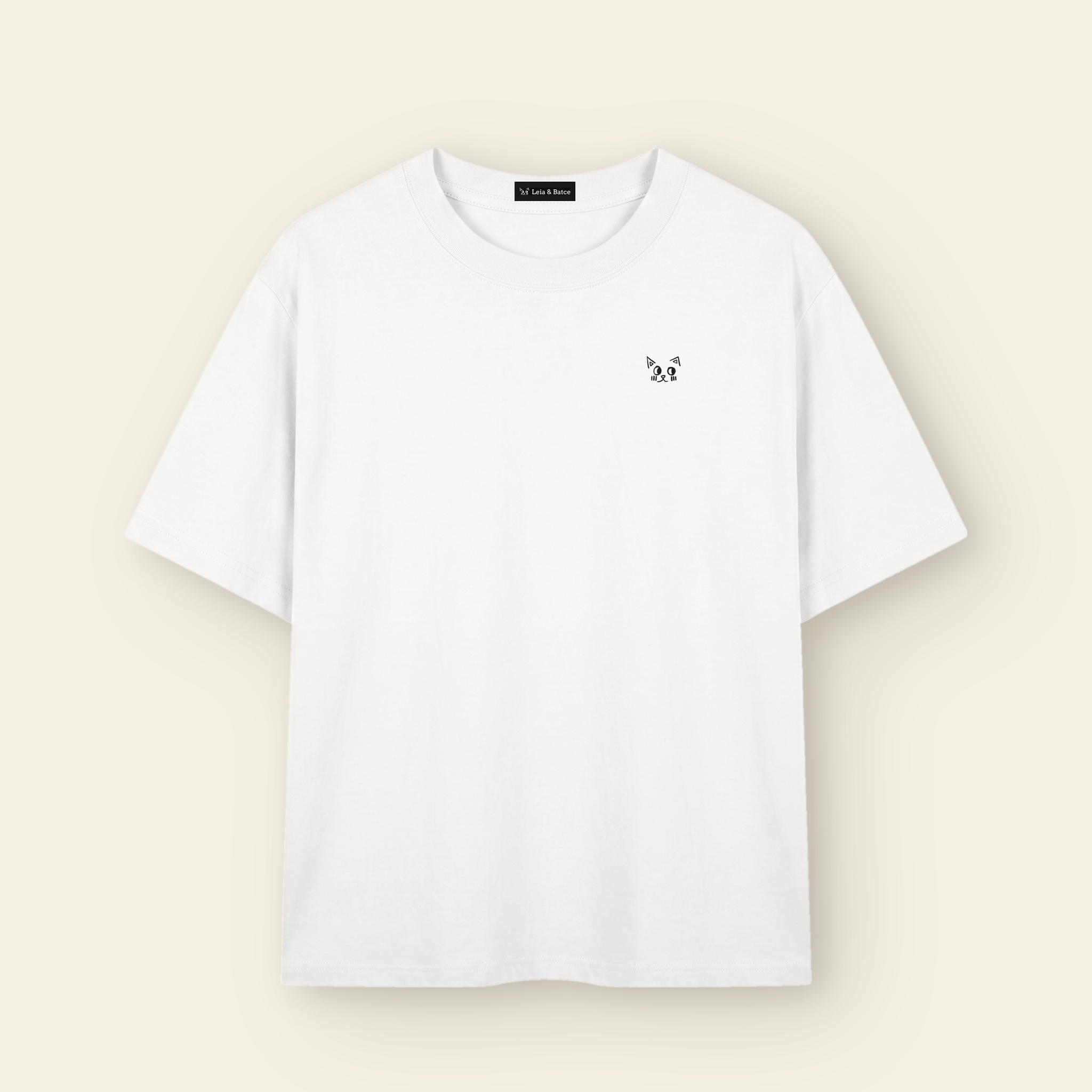 The Batce T-Shirt - Adult in White with the hand-drawn Batce mark and woven brand label.