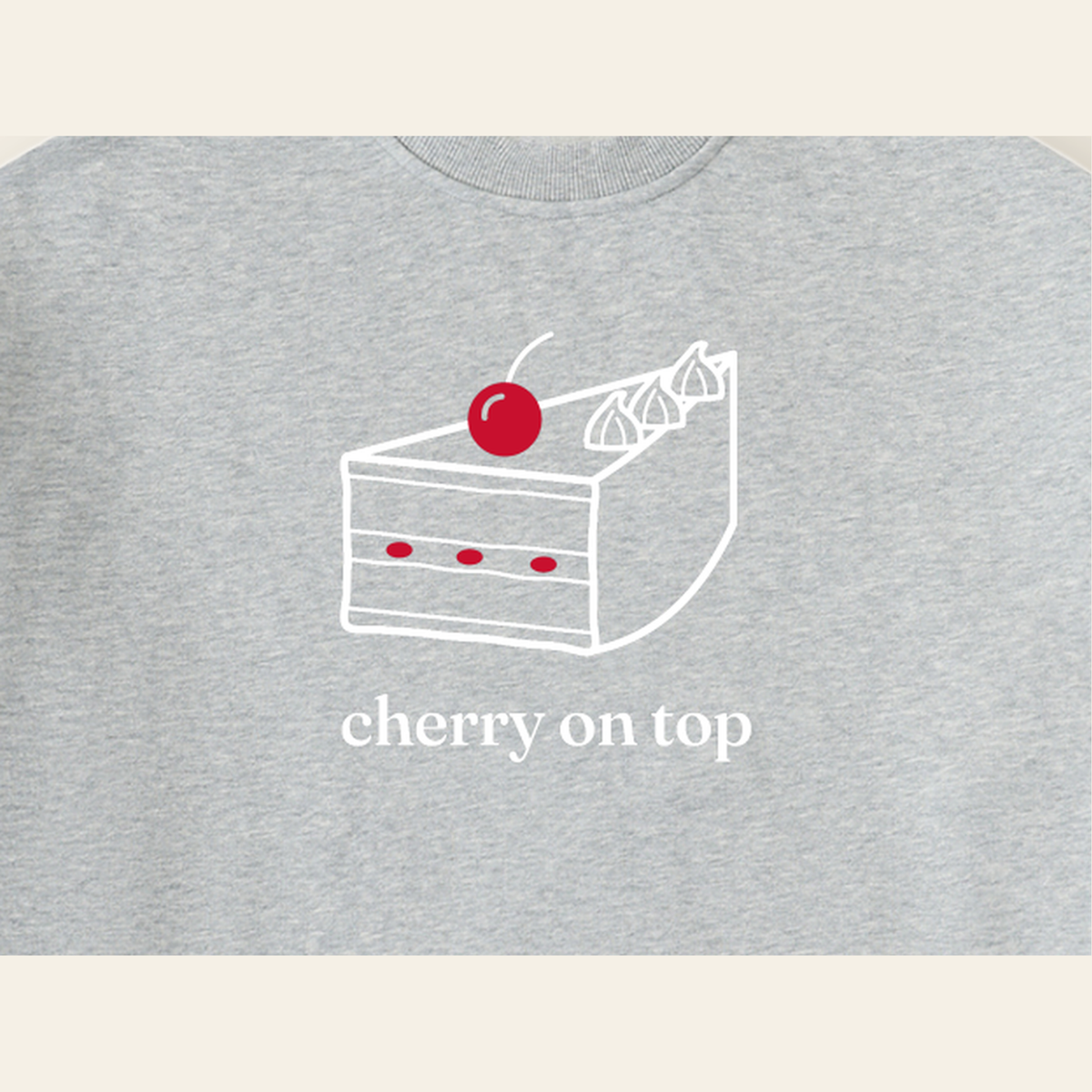 Close-up of the Cherry on Top mark printed on the Heather Gray sweatshirt