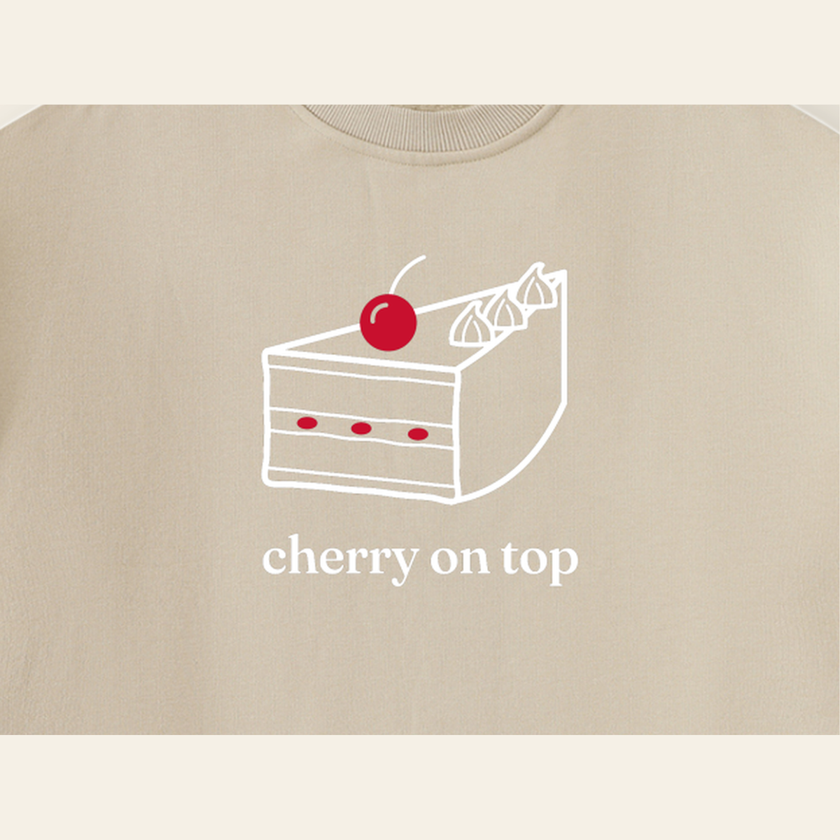 Close-up of the Cherry on Top mark printed on the Khaki sweatshirt