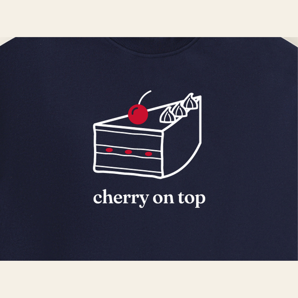 Close-up of the Cherry on Top mark printed on the Navy Blue sweatshirt