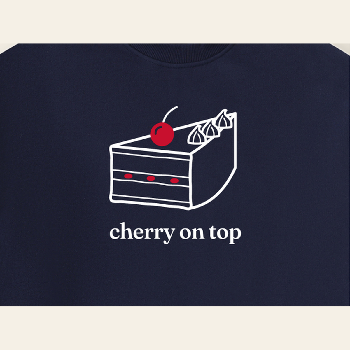 Close-up of the Cherry on Top mark printed on the Navy Blue sweatshirt