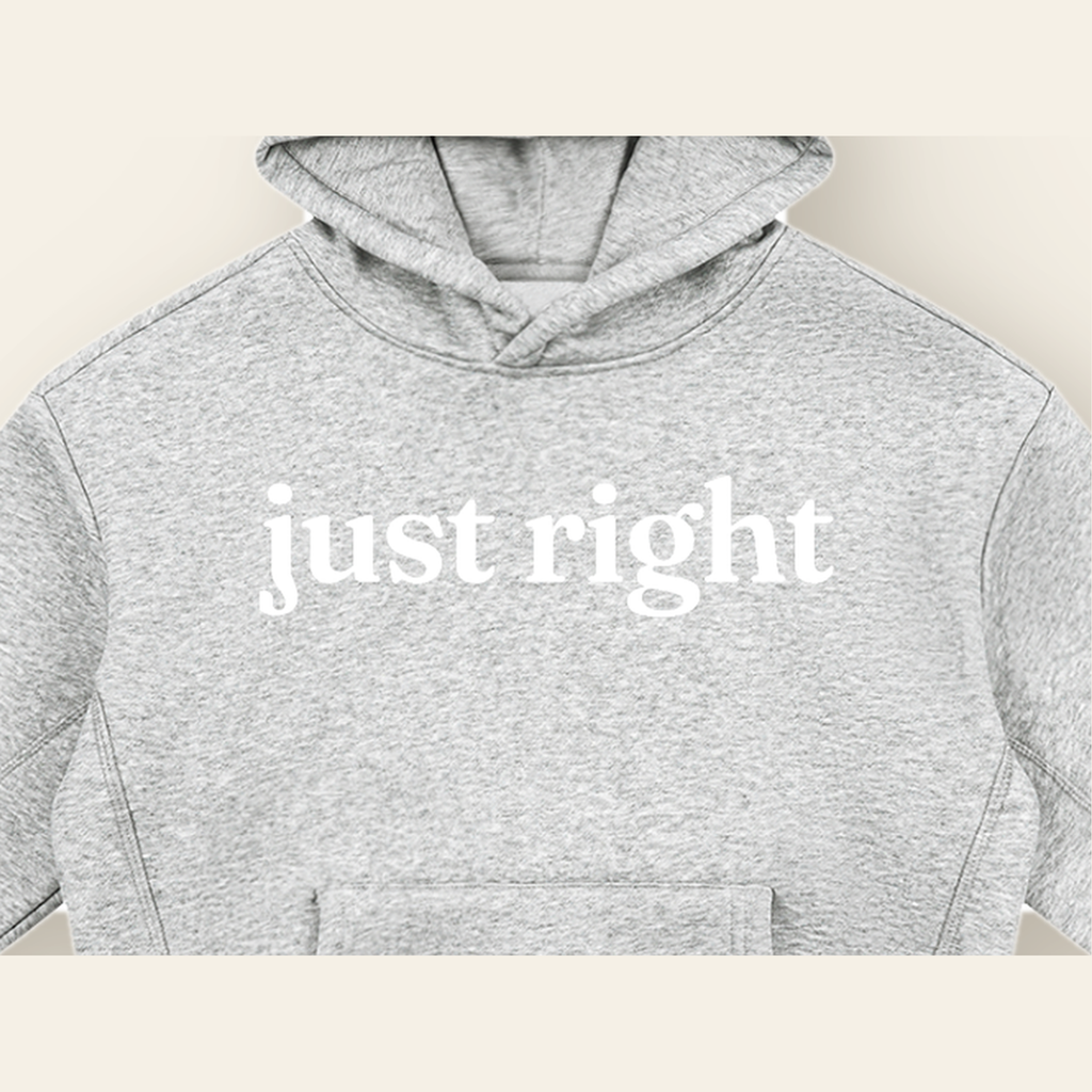 Close-up of the Just Right mark printed on the Heather Gray hoodie