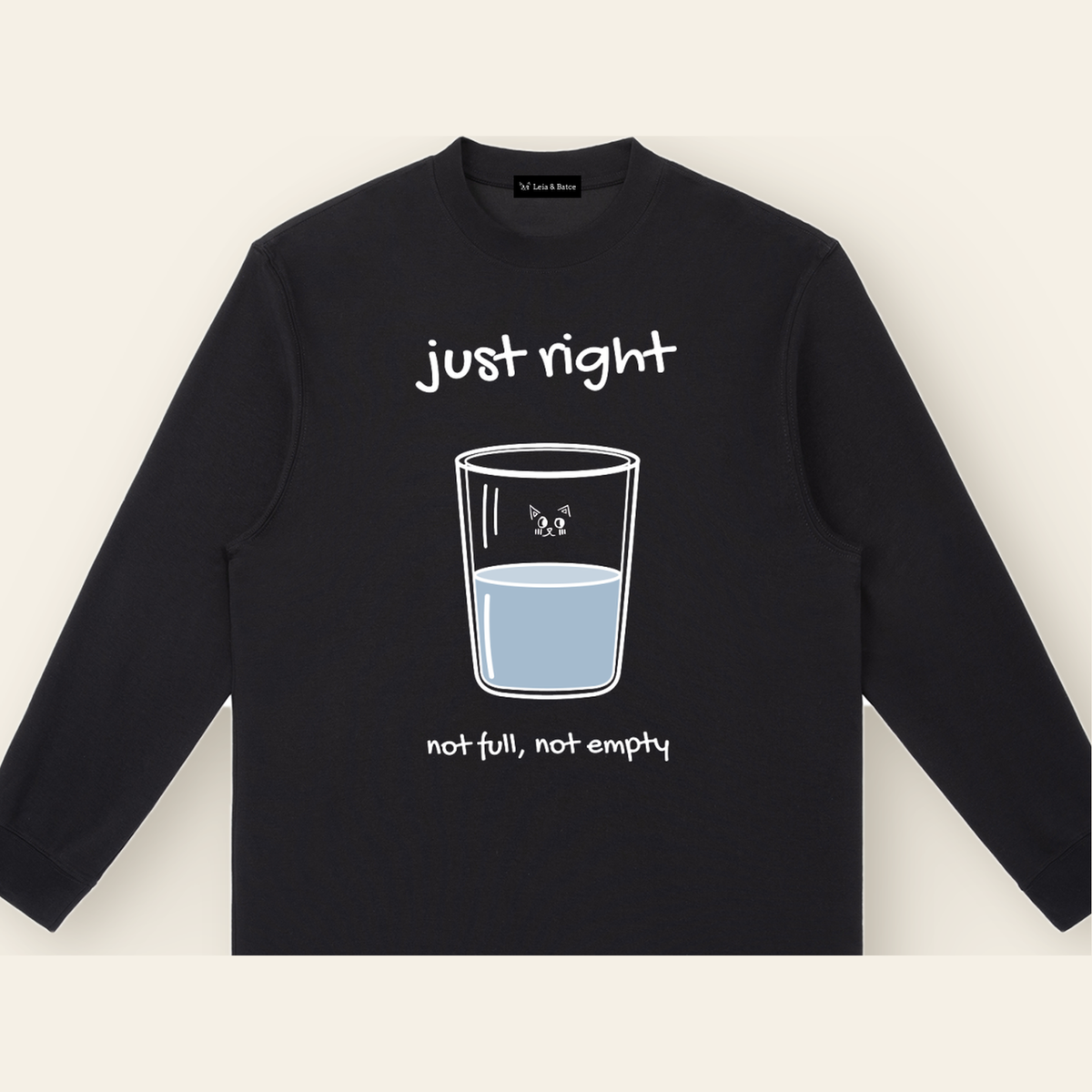Close-up of the Just Right mark printed on the Black long-sleeve t-shirt