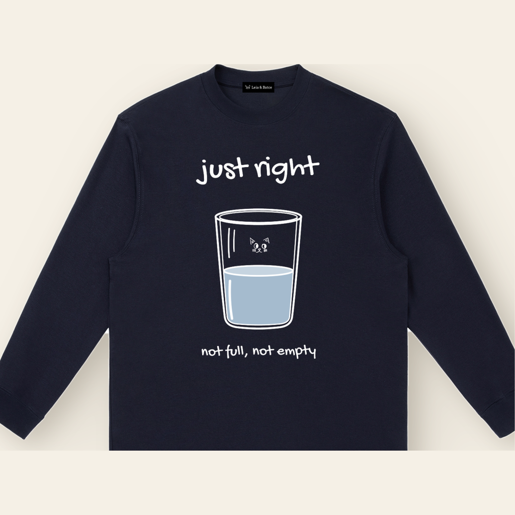 Close-up of the Just Right mark printed on the Navy Blue long-sleeve t-shirt